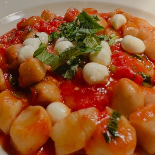 Close-up of Luna Rossa's gnocchi with tomato sauce, fresh mozzarella balls, and basil.